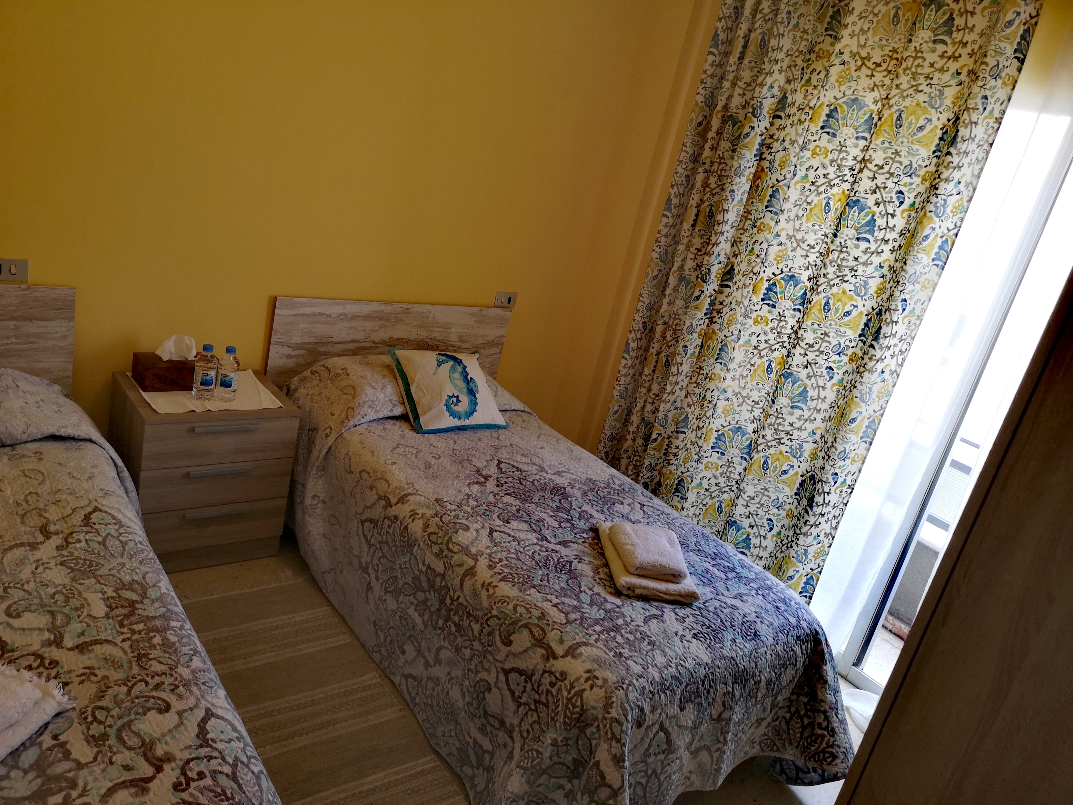 Bedroom with balcony, wide view
